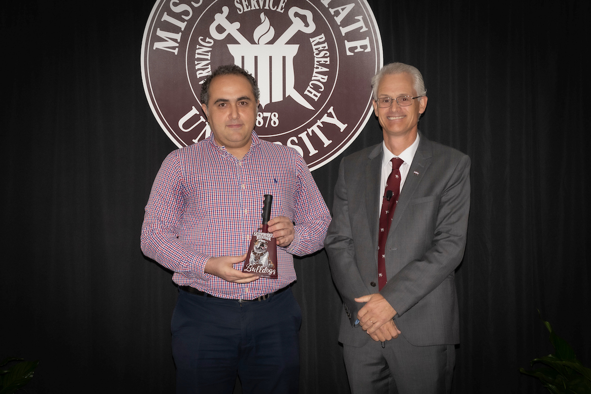 Dr. Hassan Tekadar receives the Dean’s Pegasus Award for Research/Creative Achievement from Dr. Nicholas Frank.