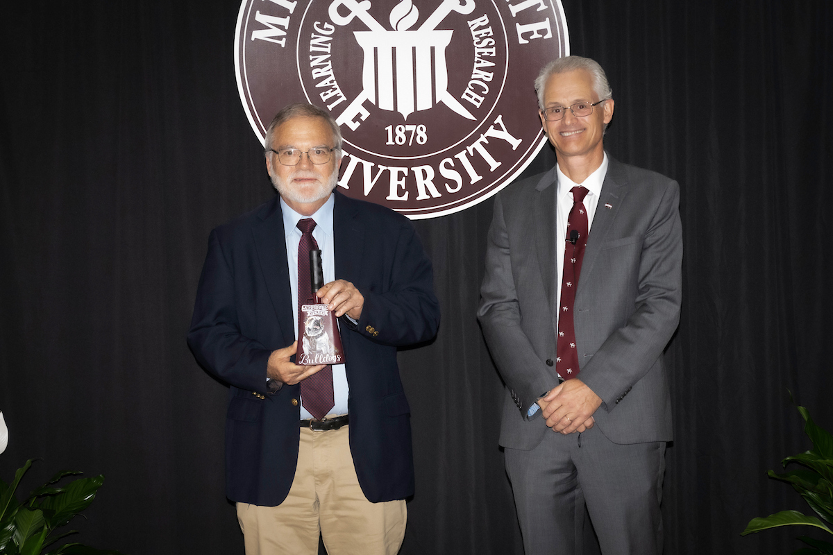 Dr. Nick Frank presents the Dean's Pegasus award to Dr. Bob Wills.