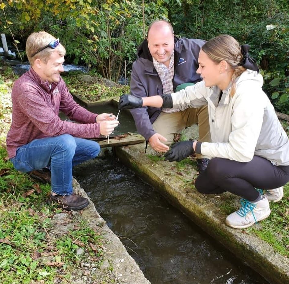 Two veterinarian instructors and a student test some water.